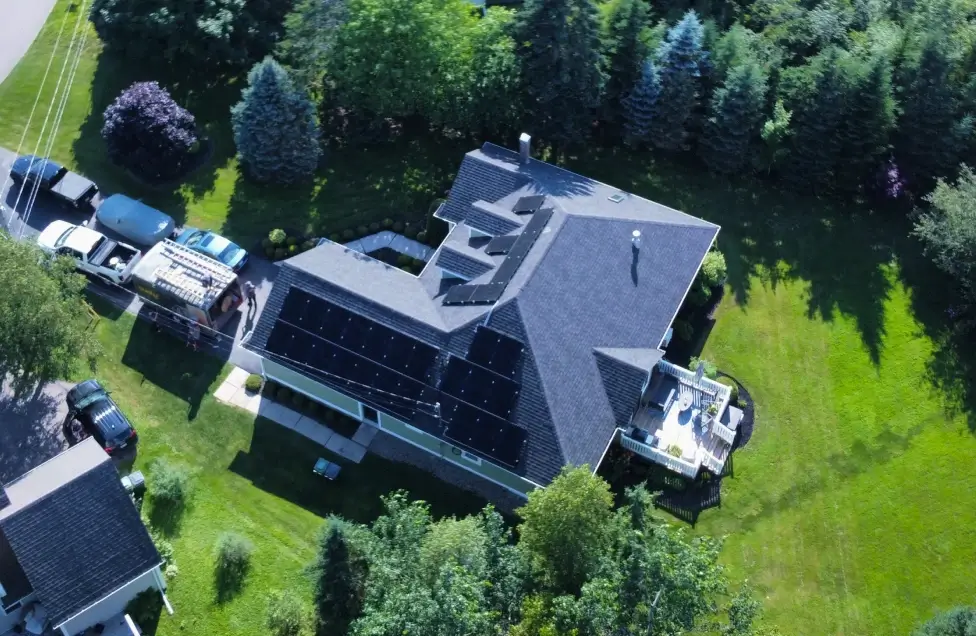 Sleek black solar panels integrated into a modern multi-gabled roof in PEI, showcasing how renewable energy solutions can enhance a property's aesthetic and equity.