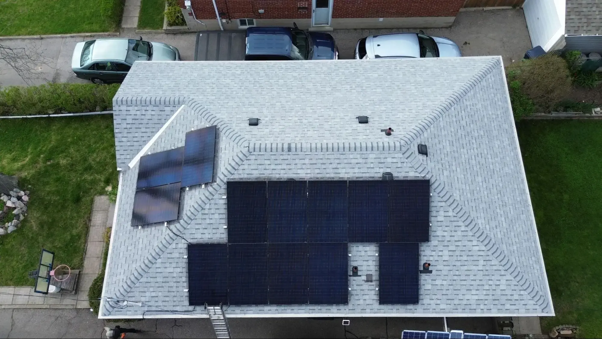 Aerial view of a completed Ontario home solar installation with sleek black panels, verified by a satisfied customer review for Polaron’s after-service care.